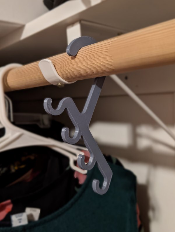 Photograph of 3D printed closet hanger for belts, designed by Colton.